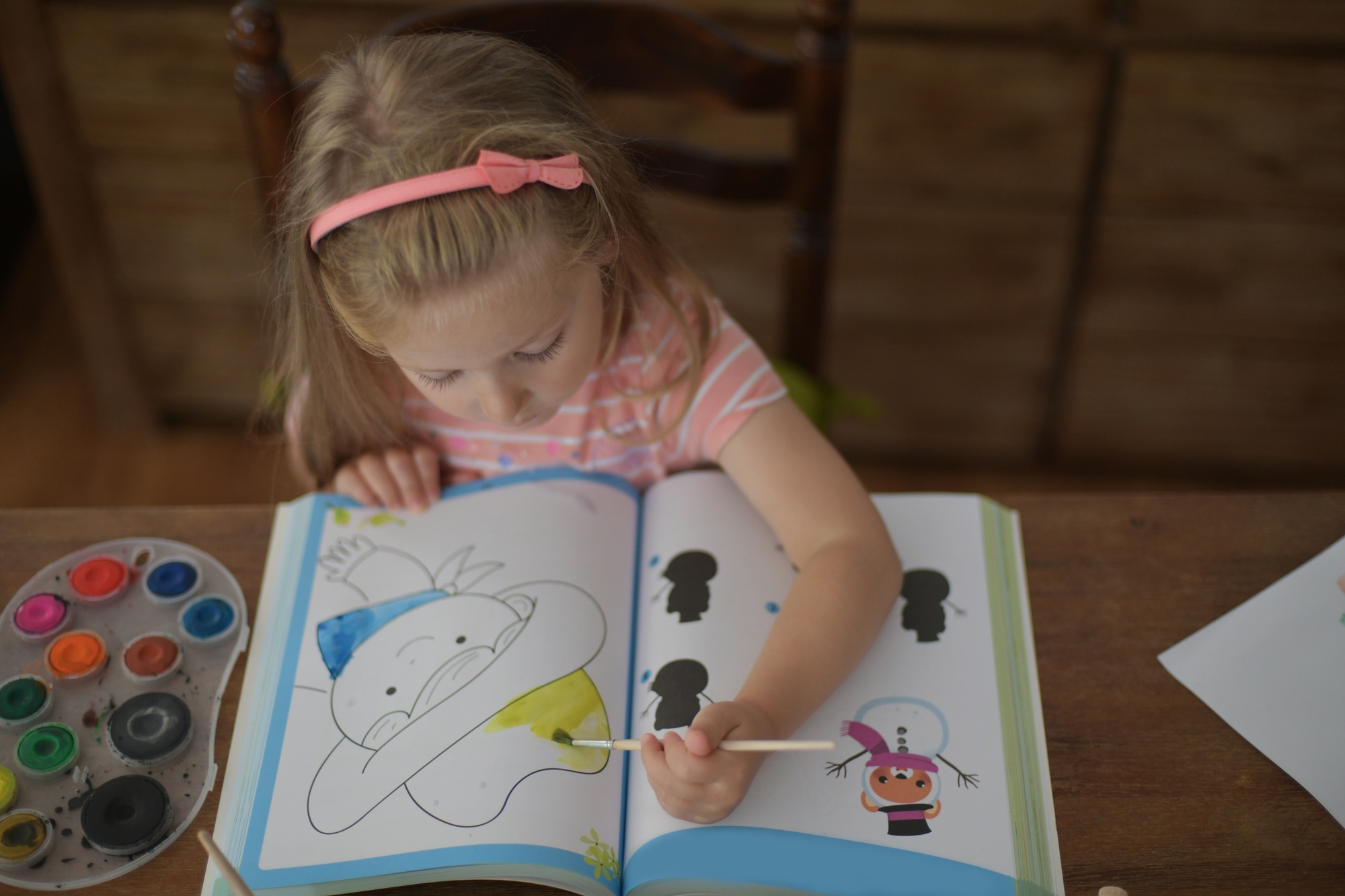 A girl draws at home