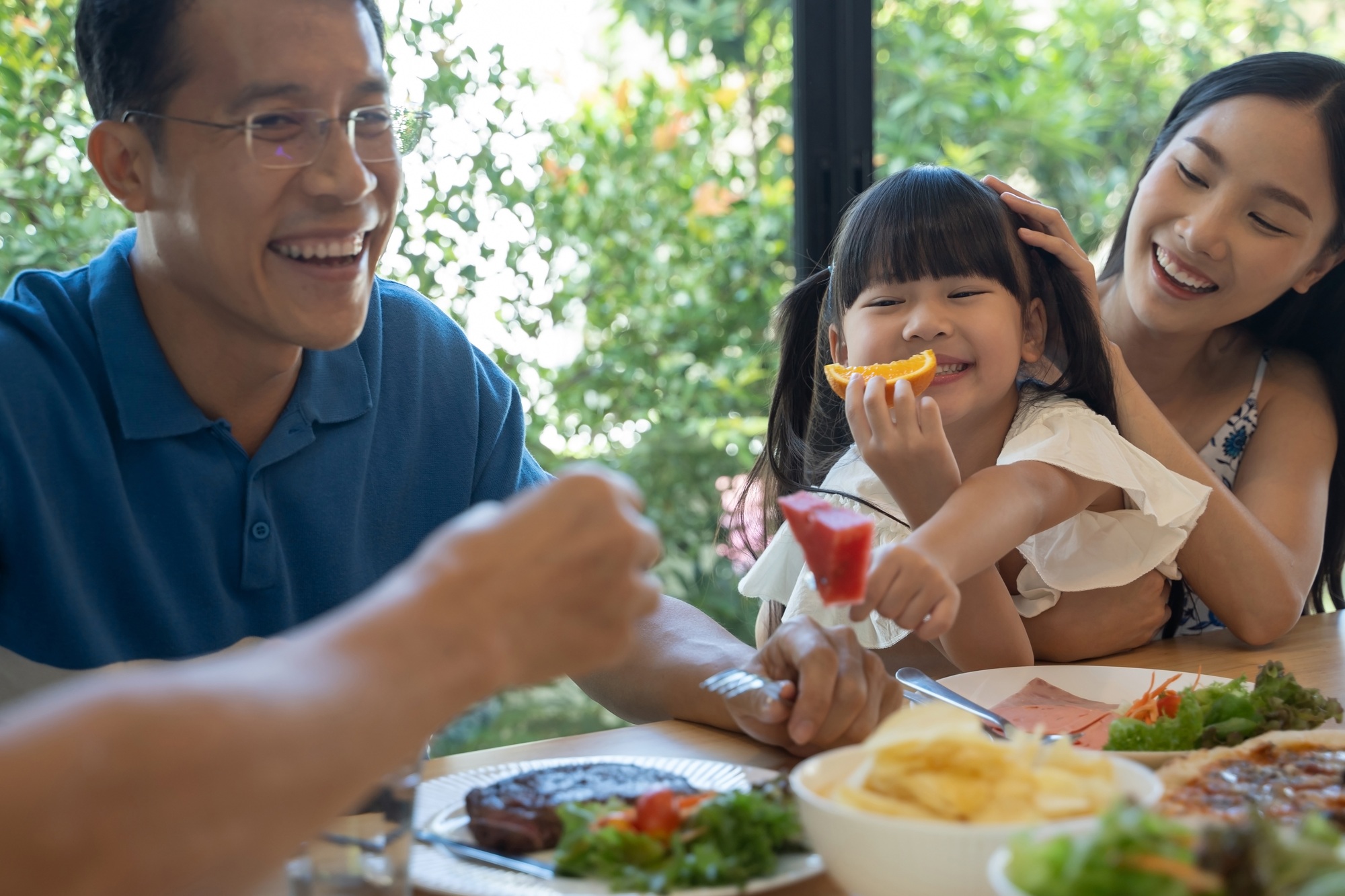 Asian family having a happy meal.