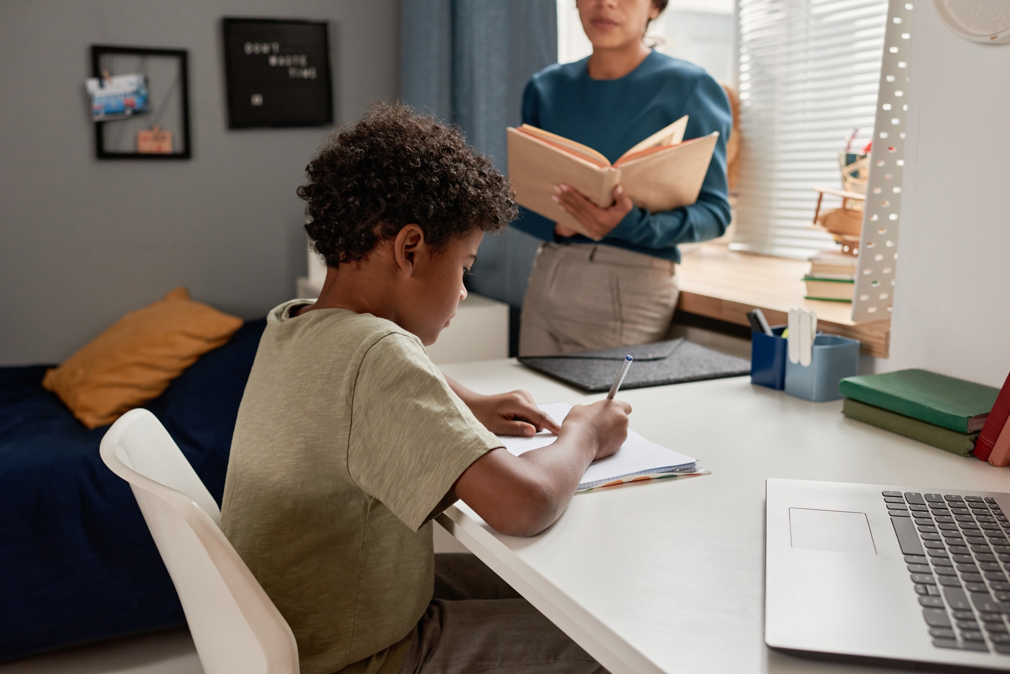 Boy preparing for dictation with tutor
