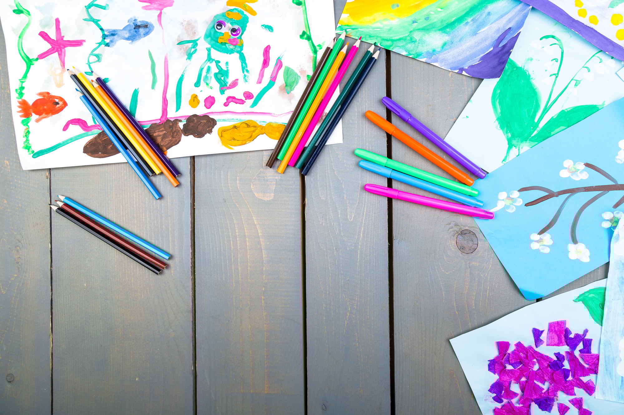 Child pictures. Kid drawings. Flat lay. Copy space.