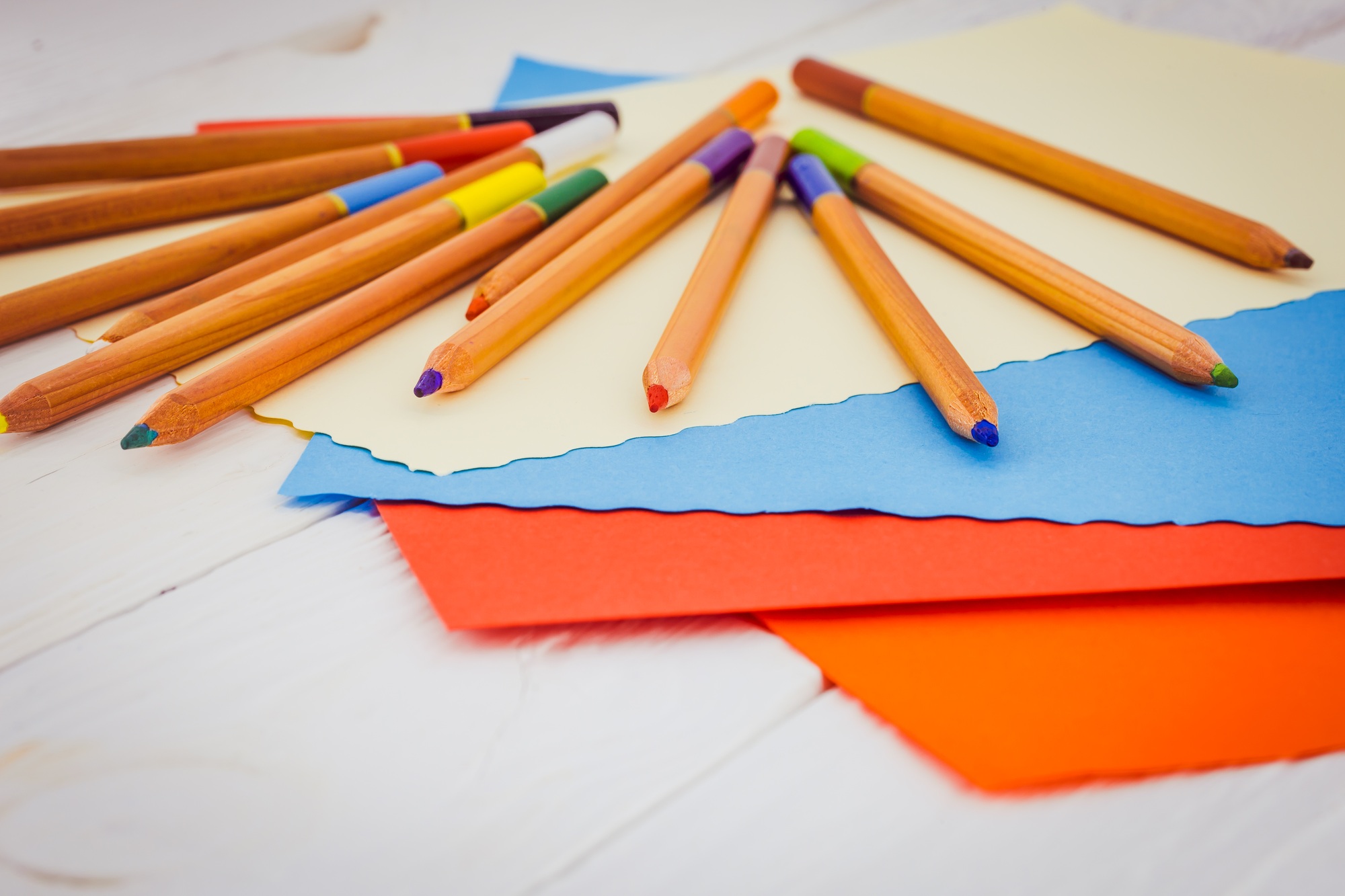 colored pencils on a background of color paper