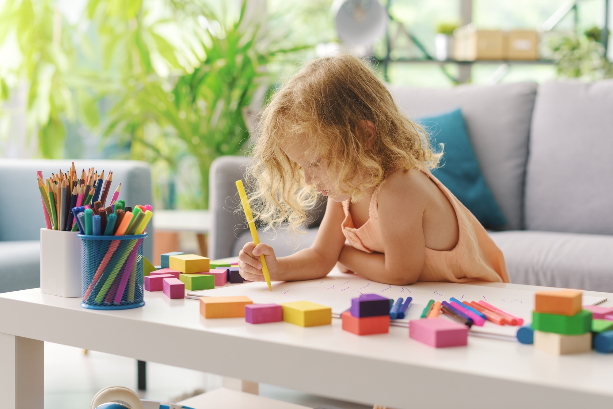 Cute girl coloring with markers