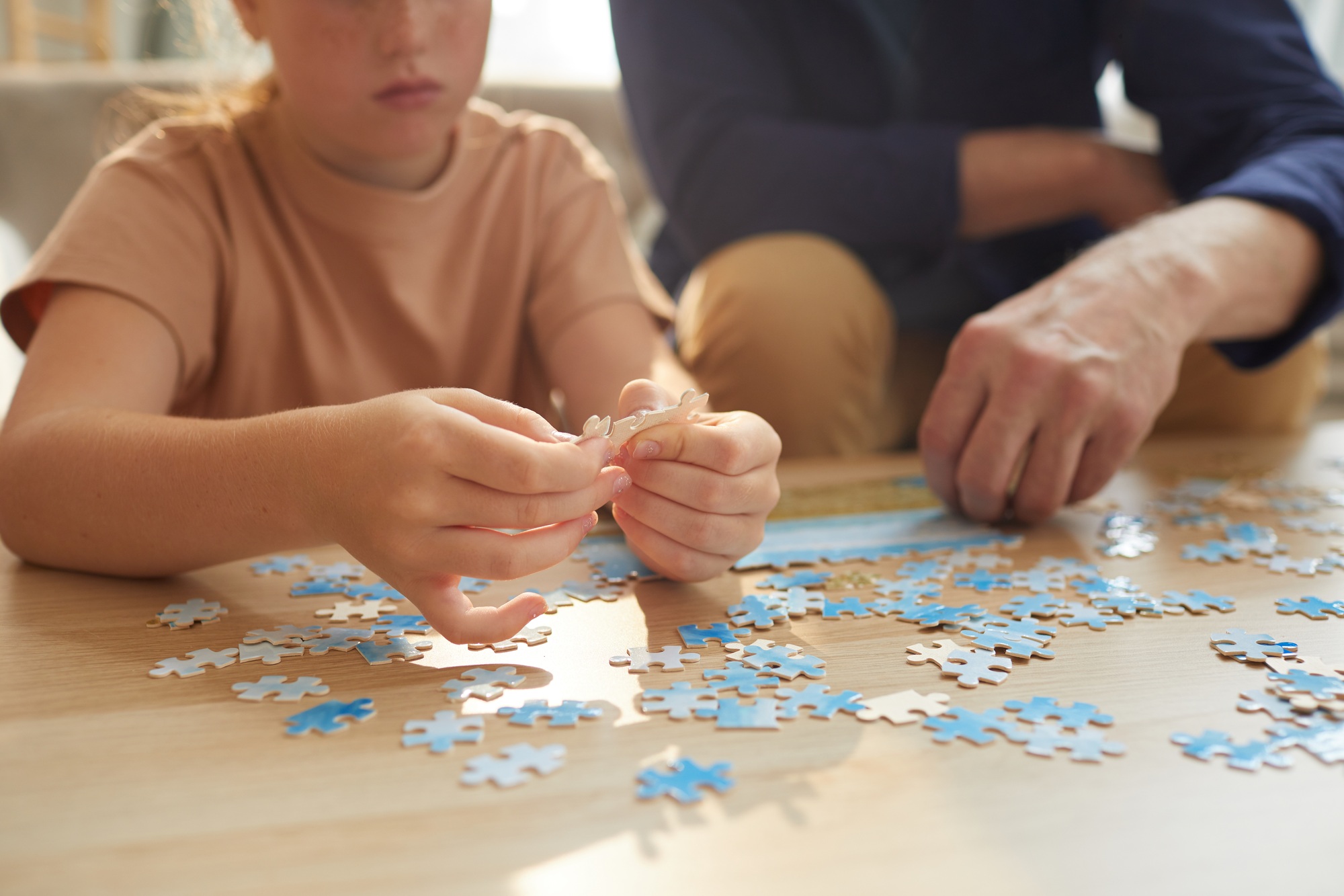 Girl Assembling Puzzle Close Up