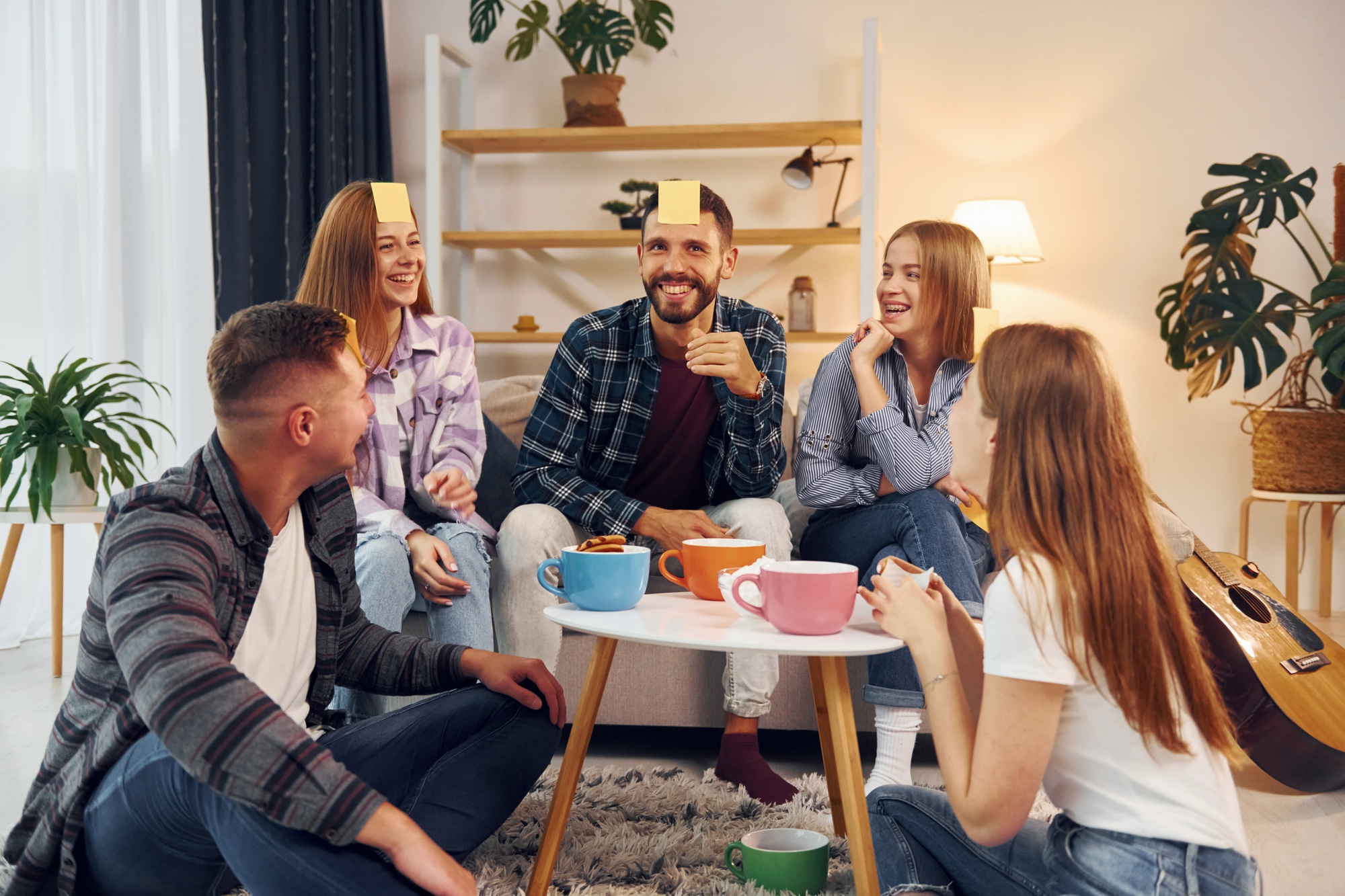 Trying to guess who I am. Group of friends have party indoors together